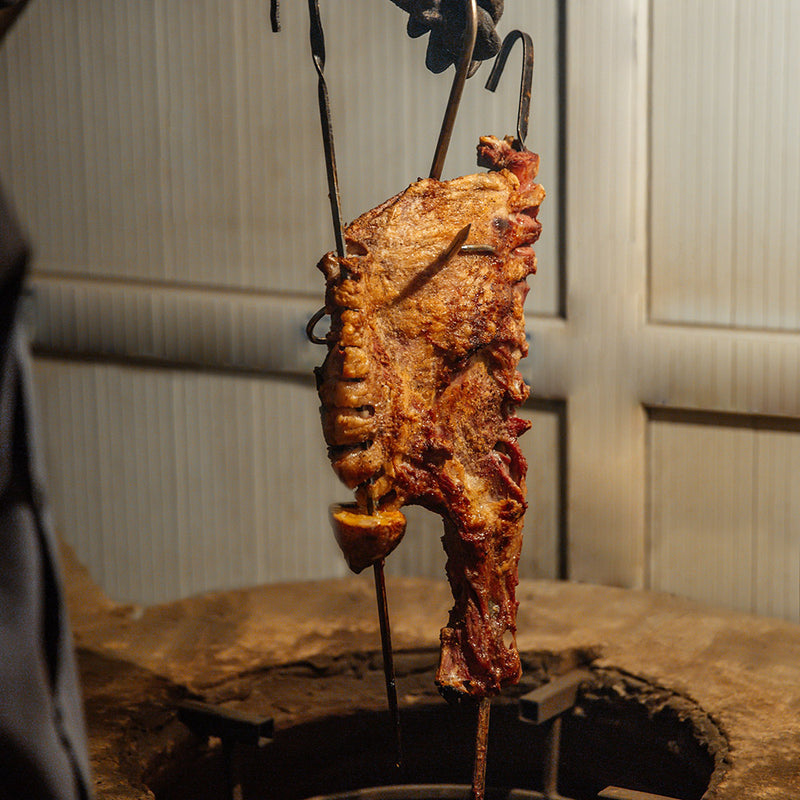 Grilled meat on a skewer over a rustic background