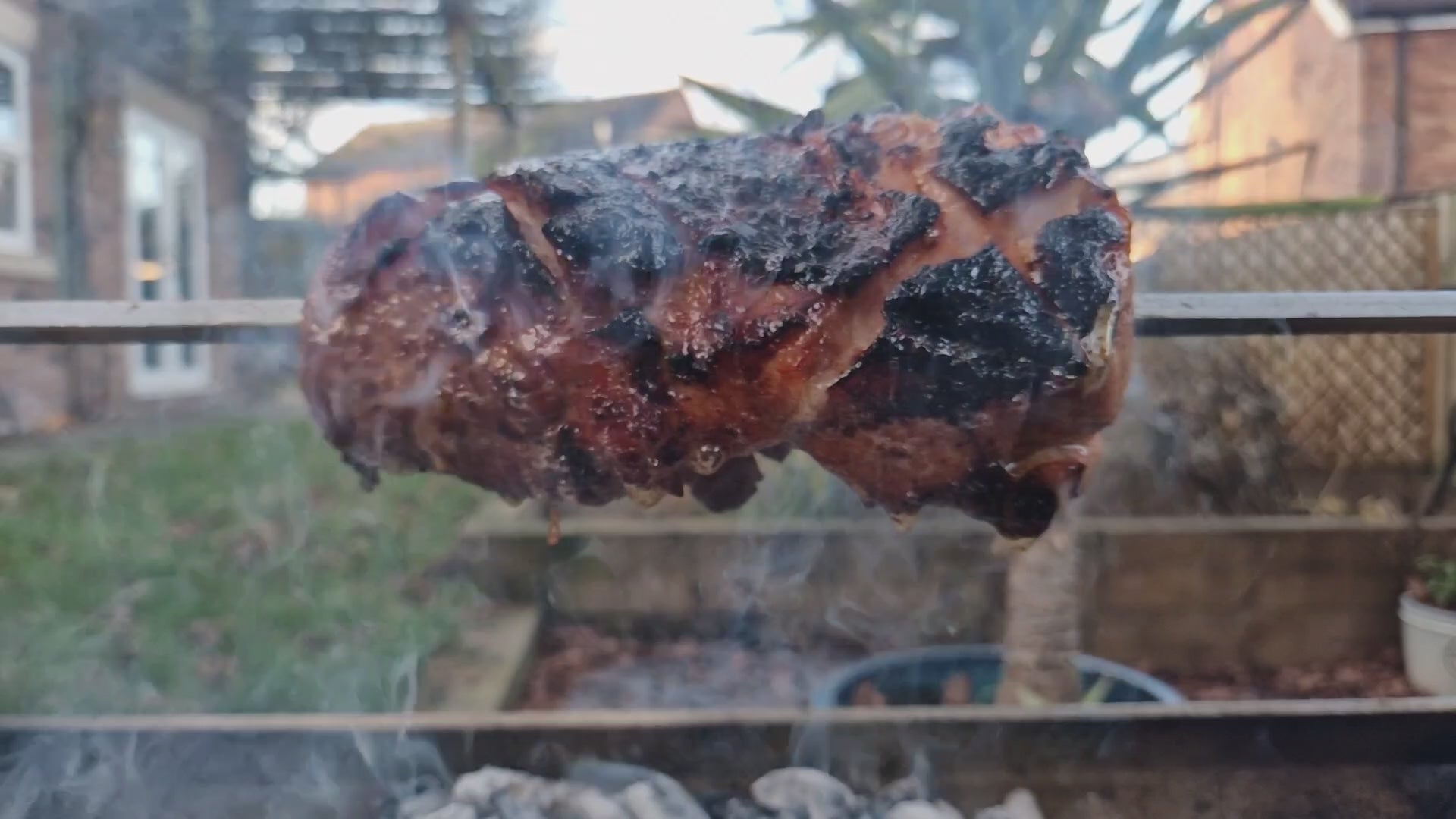 Joint of ham basting and turning on the Rozza