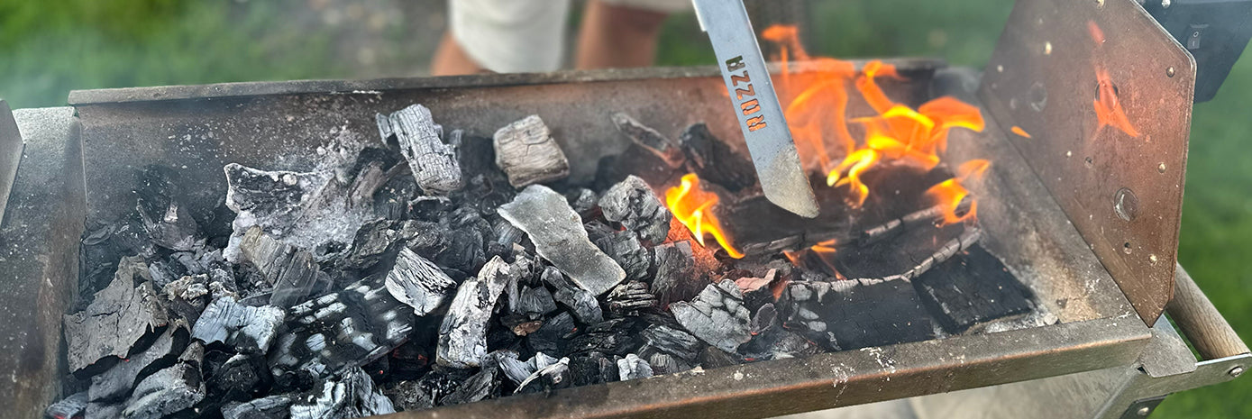 Rozza with charcoal and flames, being used for cooking.