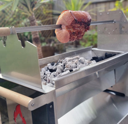 Skewer with food cooking over the rozza grill outdoors