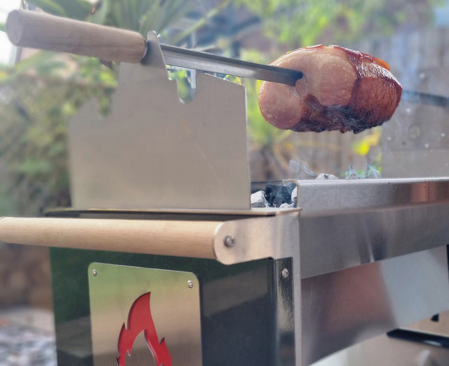 Rozza with a piece of meat being cooked outdoors